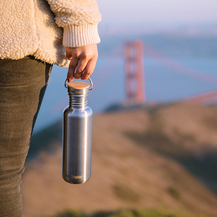 27oz-reflect-with-bamboo-cap-y3 K27SSLRF-BS-BAMBOO_reflect_bottle_bridge_lifestyle.jpg